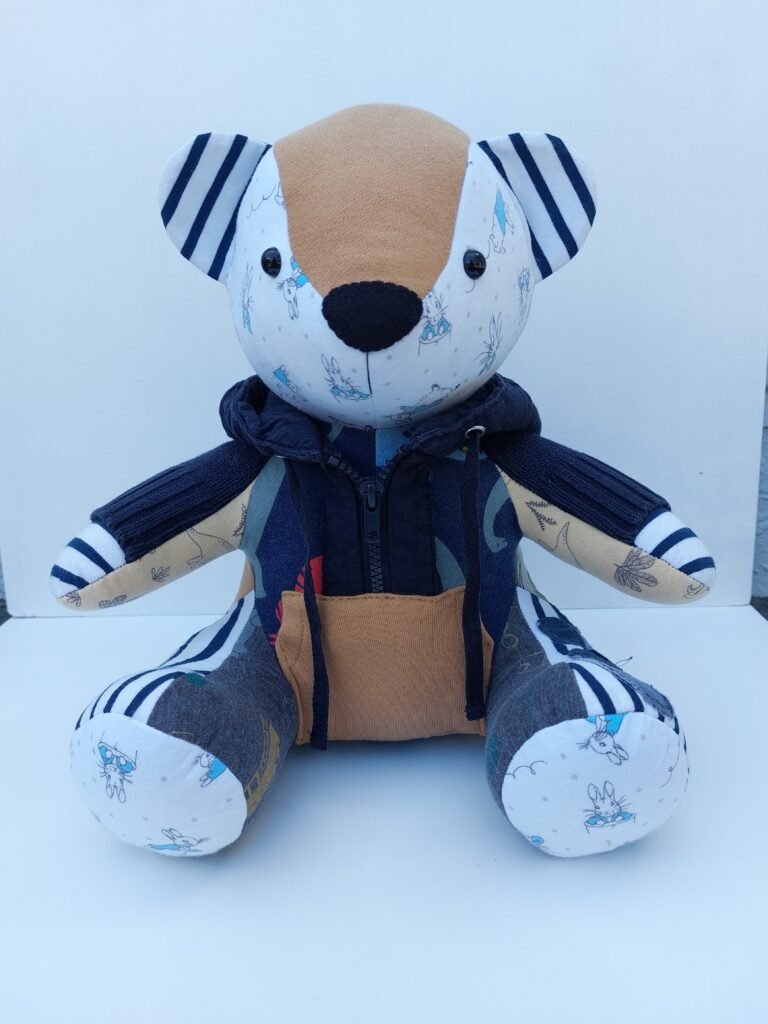 “Tiny socks, tiny hat, tiny bear — made from the clothes that started it all.”