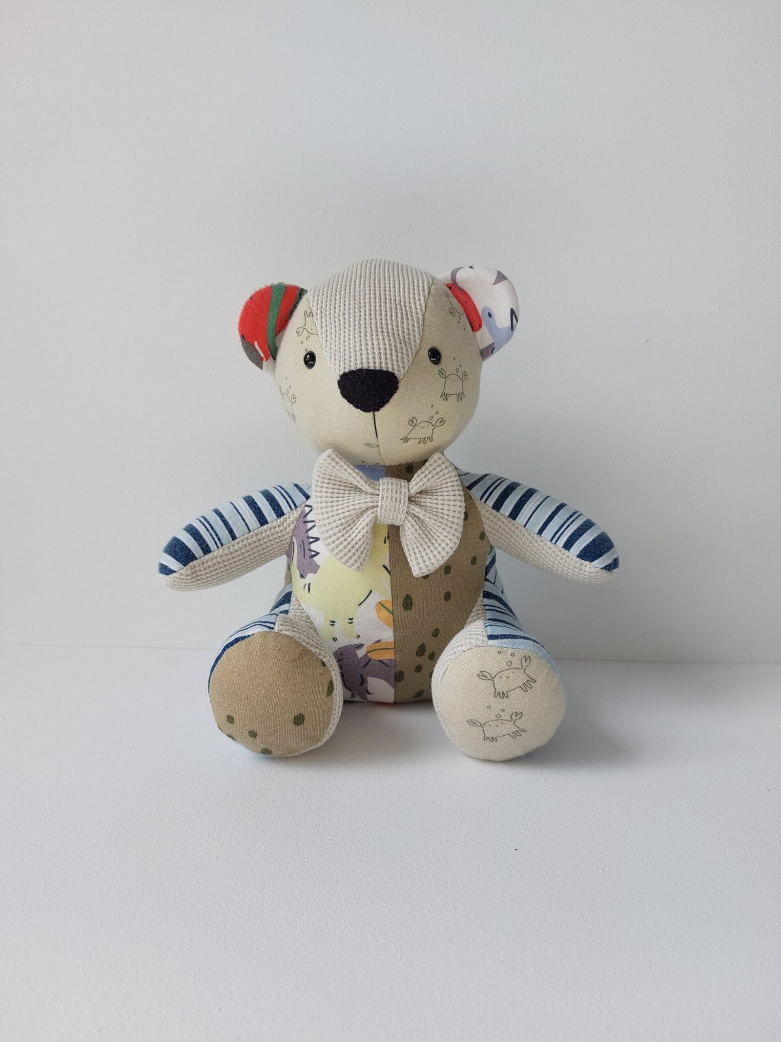 Small sized keepsake memory bear which has been handmade from babies first clothing items
