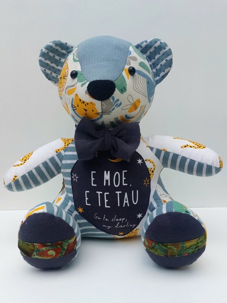 Memory Bear made from babies clothing with Maori writing on the front