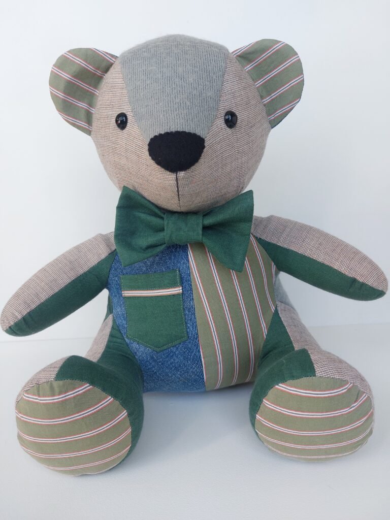Memory bear in shades of green with a pocket on the front ready to send in New Zealand
